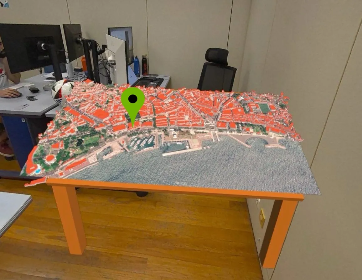 A 3D city model on a table, seen in augmented reality
