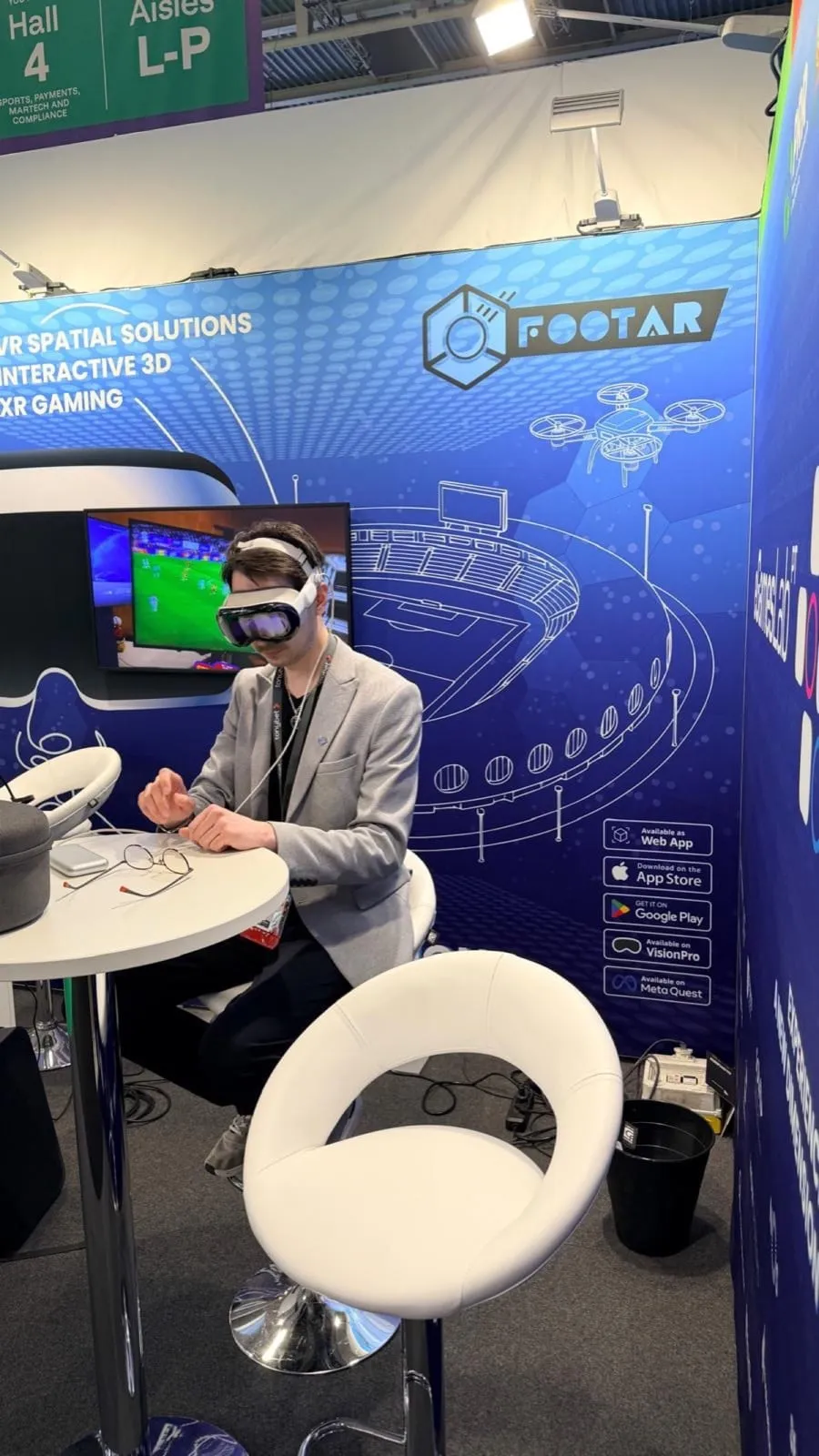 A visitor wearing Apple Vision Pro at the FootAR stand